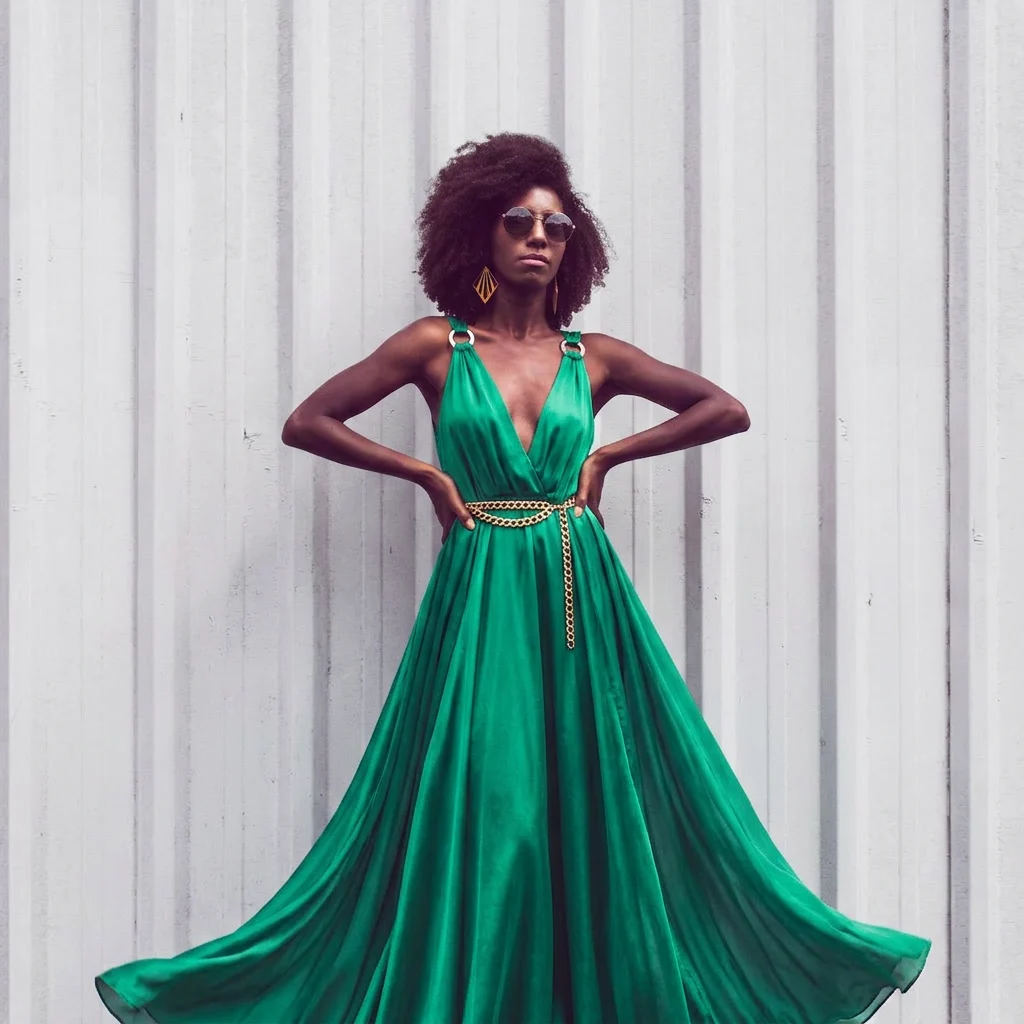 AI generated image: Have the model wear a vibrant emerald green silk maxi dress, flowing lightweight fabric with a subtl